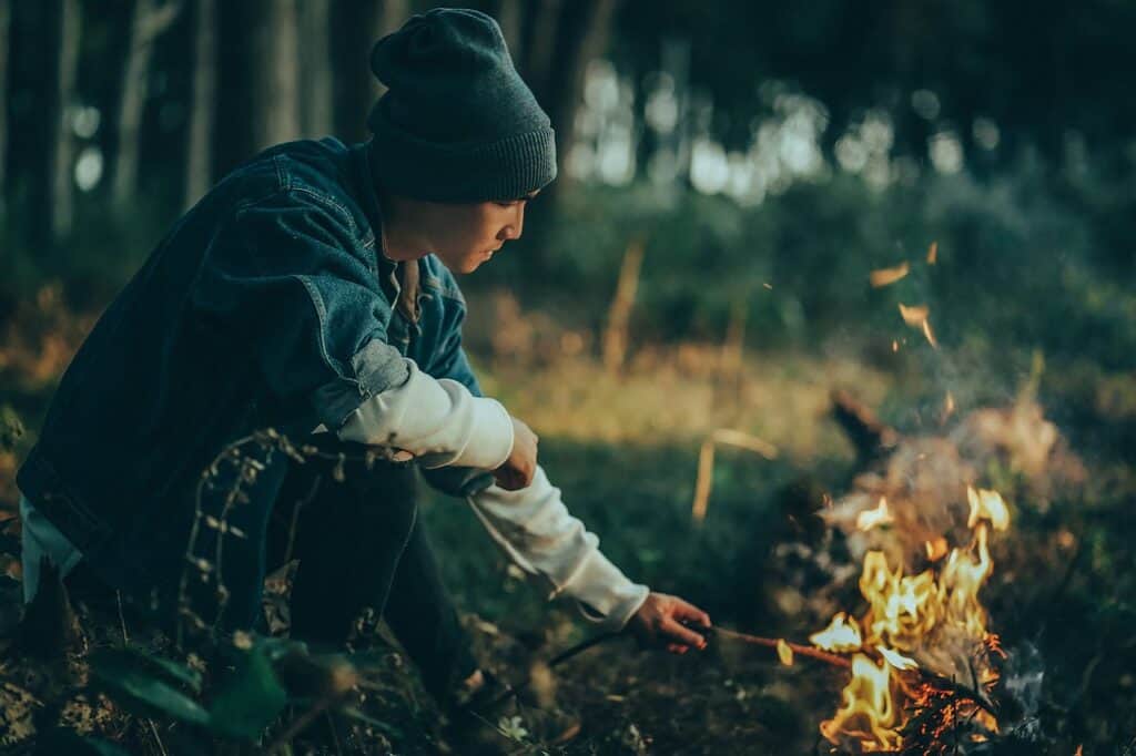 Man Poking Campfire